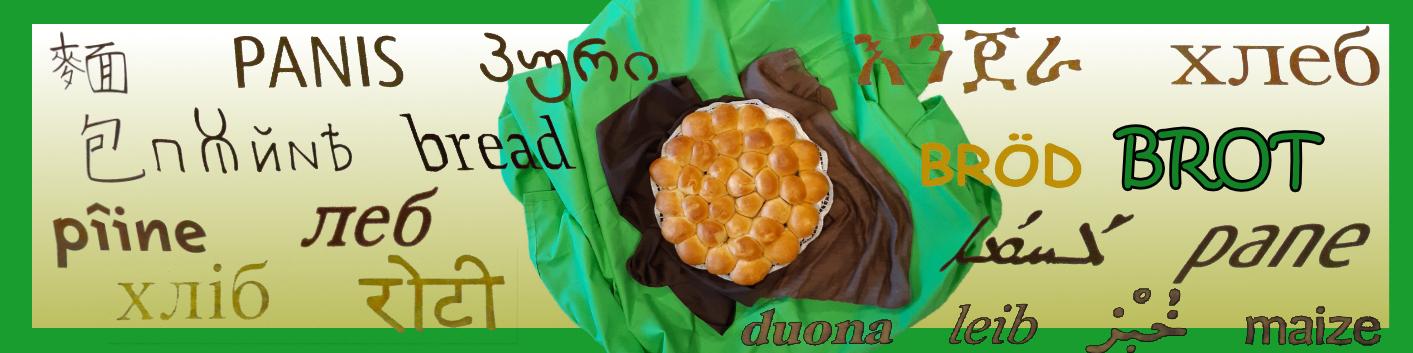 gebackenes Brot auf grünem Tuch, rund herum steht das Wort 'Brot' in verschiedenen Sprachen